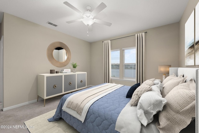 bedroom featuring ceiling fan and light colored carpet