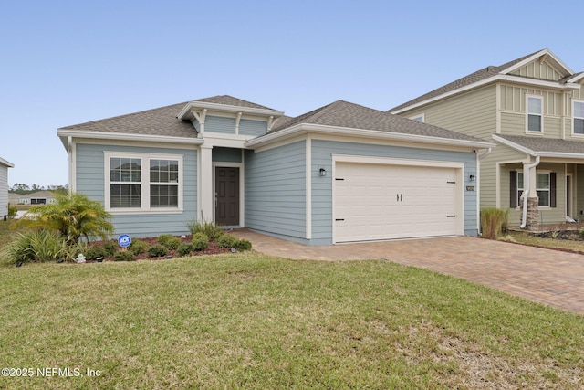 view of front of house with a garage and a front lawn