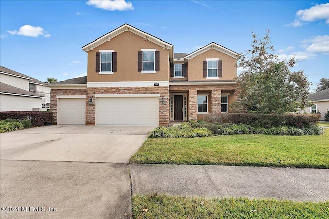 view of front of property featuring a front yard and a garage