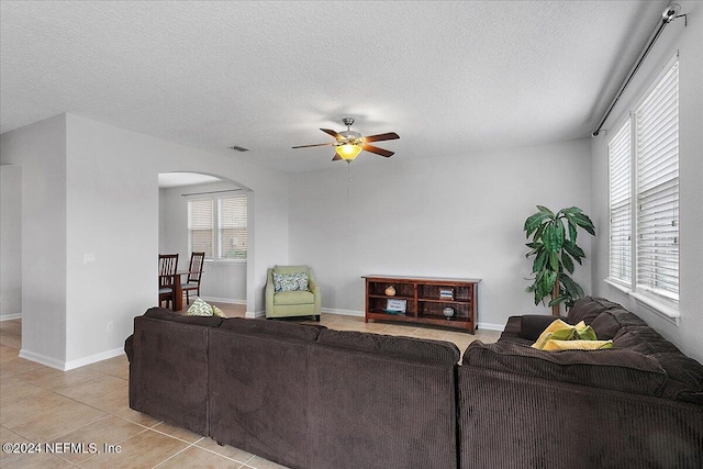 tiled living room featuring plenty of natural light and a textured ceiling