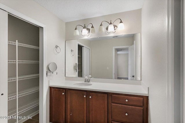 bathroom with vanity and a textured ceiling