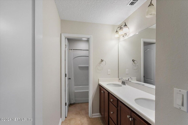 bathroom featuring vanity, shower / tub combination, and a textured ceiling