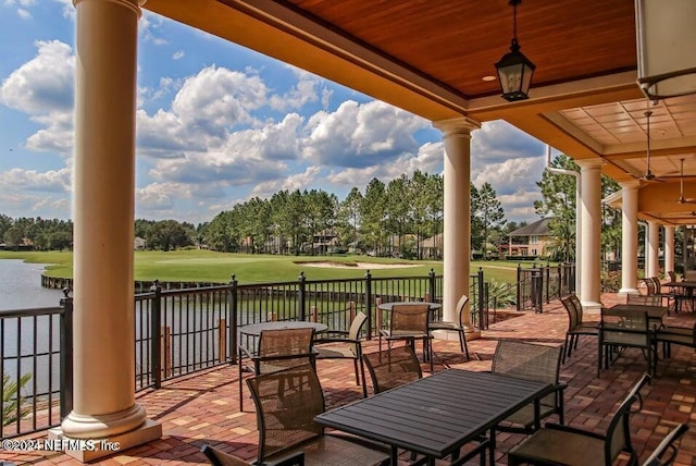 view of patio / terrace featuring ceiling fan and a water view