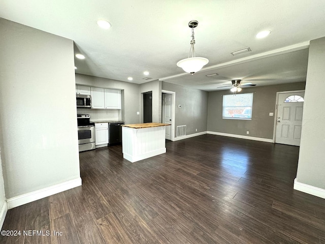 kitchen featuring white cabinets, wood counters, dark wood-type flooring, and appliances with stainless steel finishes