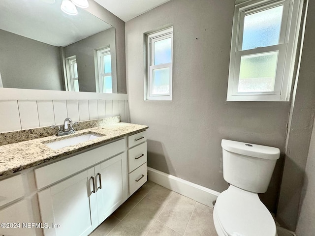 bathroom featuring toilet, vanity, and tile patterned floors