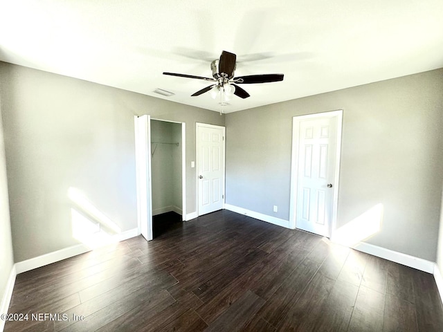 unfurnished bedroom featuring ceiling fan and dark wood-type flooring