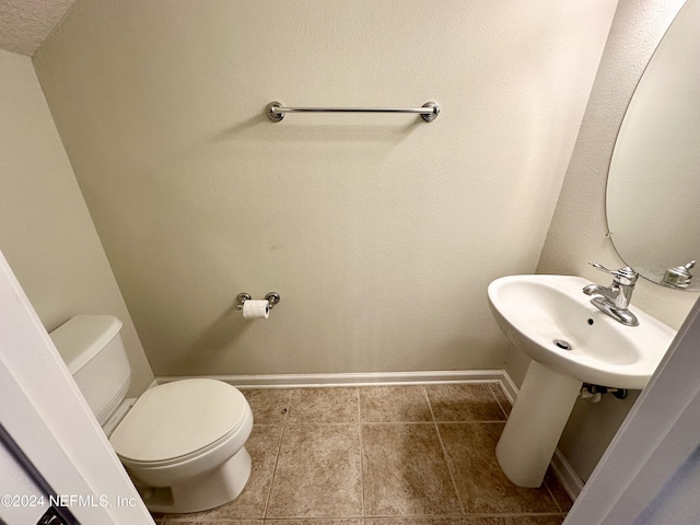 bathroom with tile patterned floors, toilet, and sink