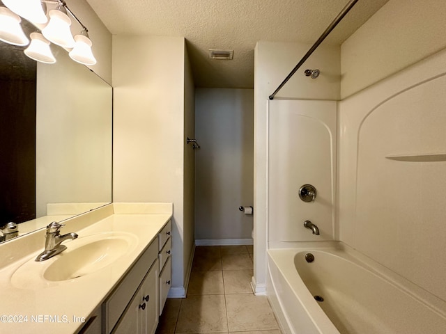 bathroom with vanity, a textured ceiling, shower / bath combination, and tile patterned floors