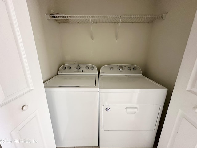 clothes washing area featuring washer and clothes dryer