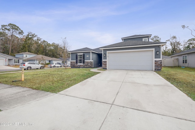 view of front of house featuring a garage and a front yard