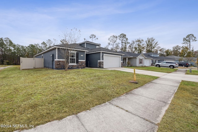 single story home featuring a garage and a front lawn