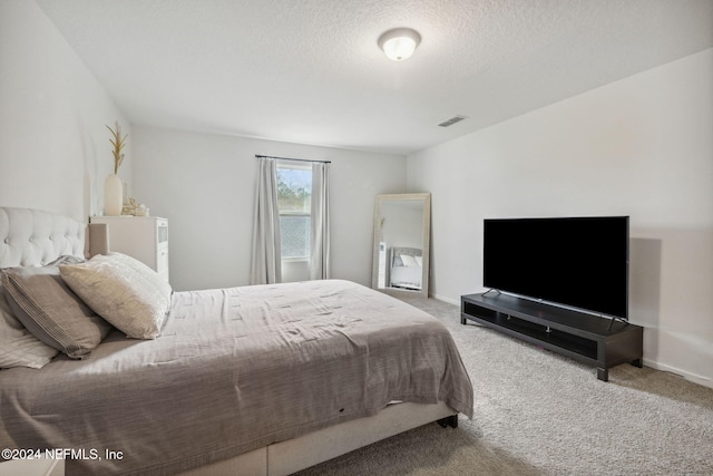 carpeted bedroom with a textured ceiling