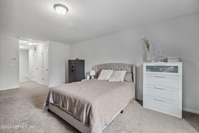 carpeted bedroom featuring a textured ceiling