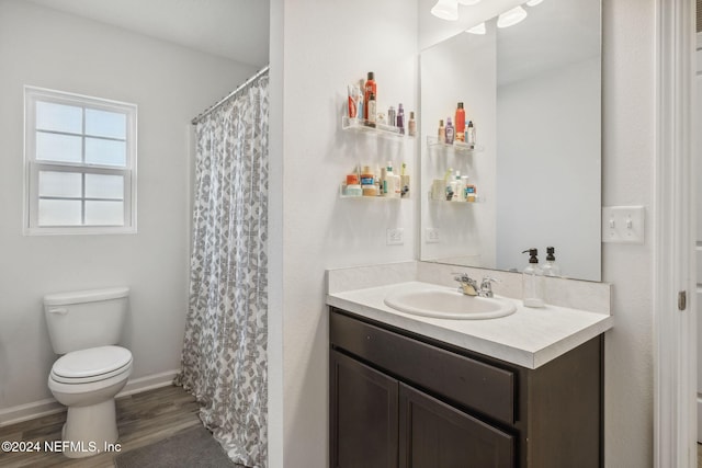 bathroom featuring hardwood / wood-style floors, toilet, and vanity