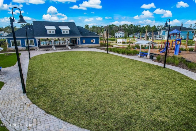 exterior space featuring a playground and a yard