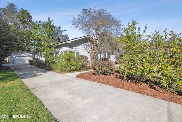 view of property hidden behind natural elements with a garage