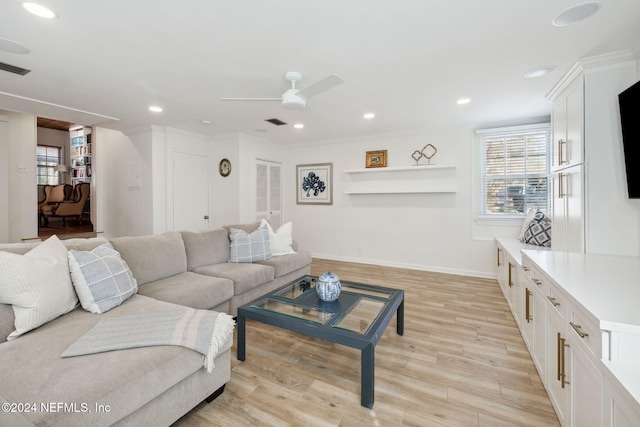 living room featuring ceiling fan, light hardwood / wood-style floors, and crown molding