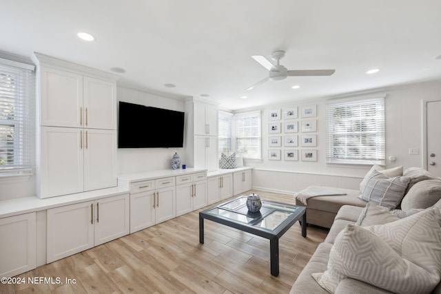 living room with ceiling fan, a healthy amount of sunlight, and light hardwood / wood-style floors