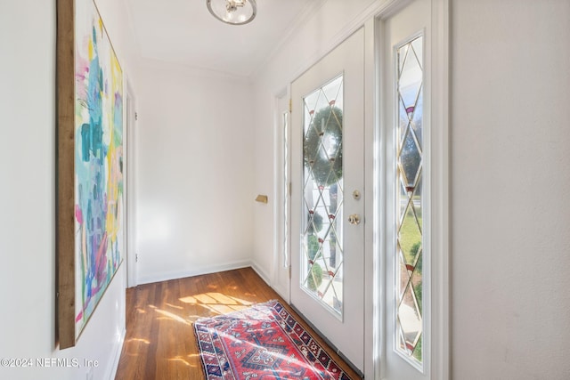 doorway with crown molding and dark wood-type flooring