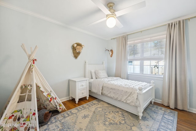 bedroom with dark hardwood / wood-style floors, ceiling fan, and crown molding