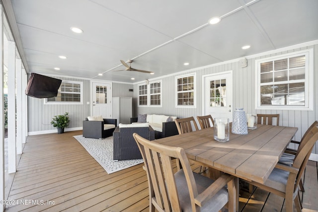 dining area with crown molding, plenty of natural light, and hardwood / wood-style flooring