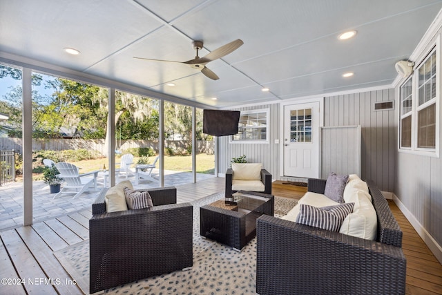 sunroom / solarium featuring ceiling fan