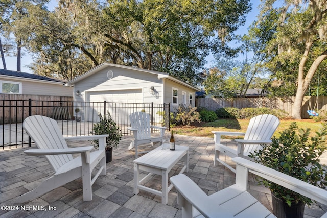 view of patio with a garage and an outdoor structure