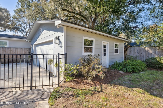 view of property exterior featuring an outdoor structure and a garage