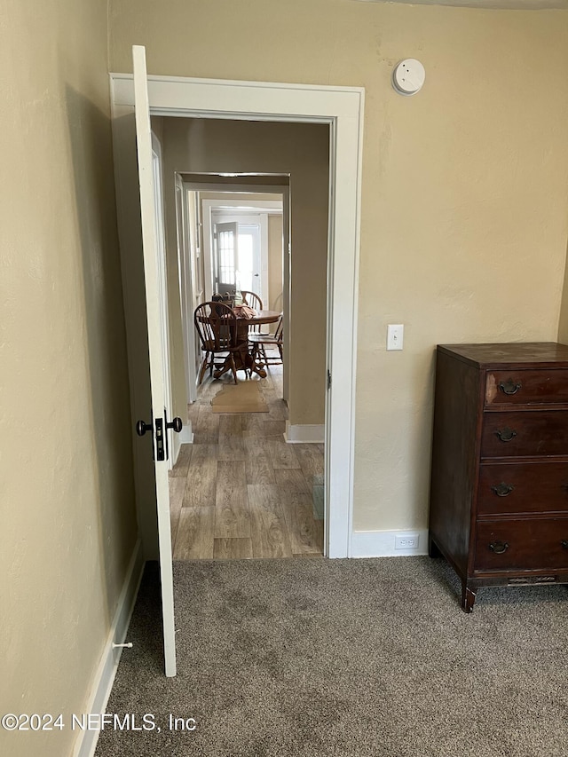 hallway with hardwood / wood-style flooring