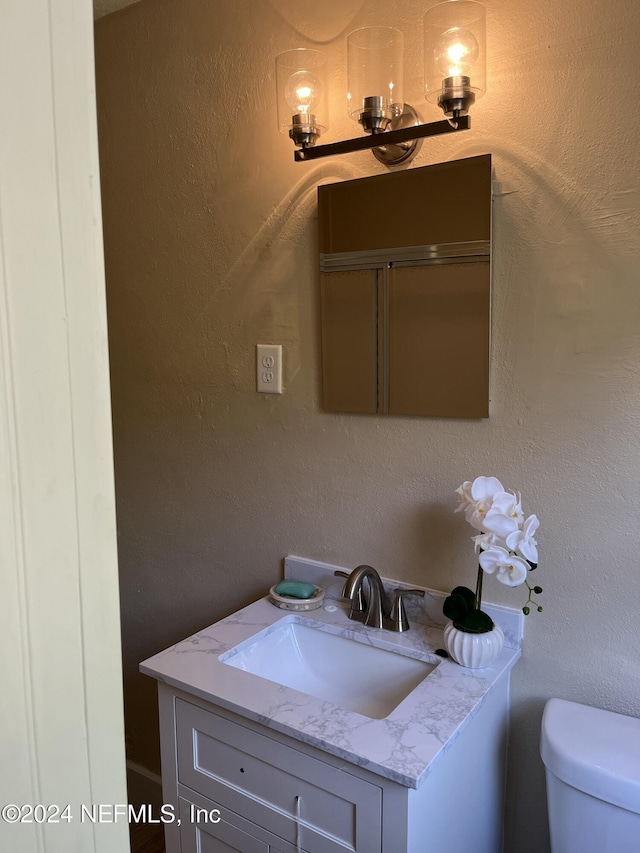 bathroom with vanity and toilet