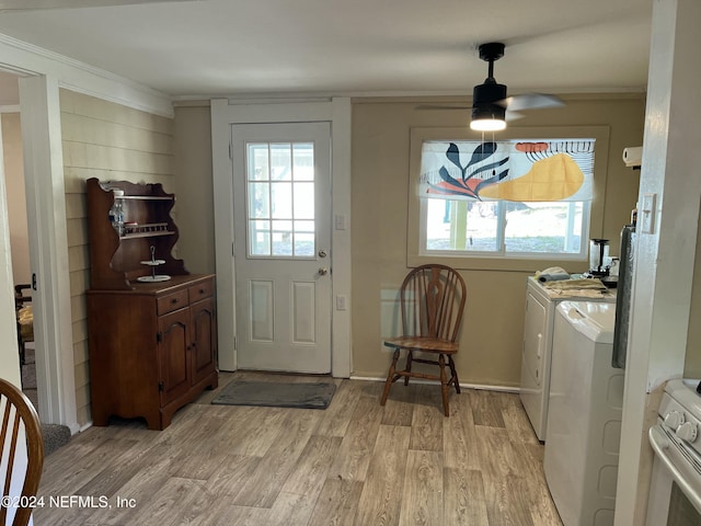 laundry area featuring ceiling fan, washer and clothes dryer, ornamental molding, and light wood-type flooring