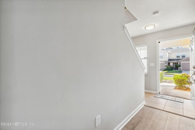 interior space with light hardwood / wood-style flooring and a textured ceiling