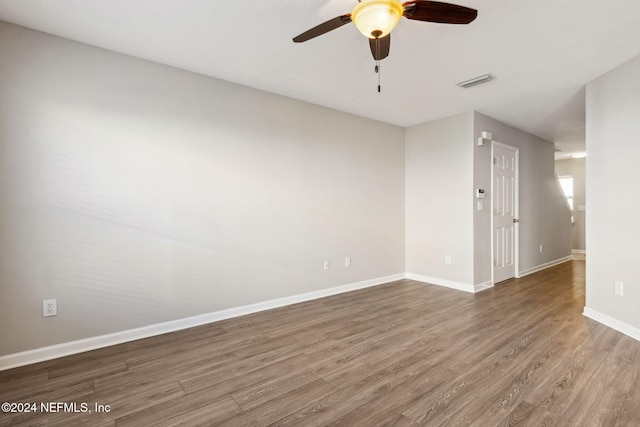 spare room with hardwood / wood-style flooring and ceiling fan