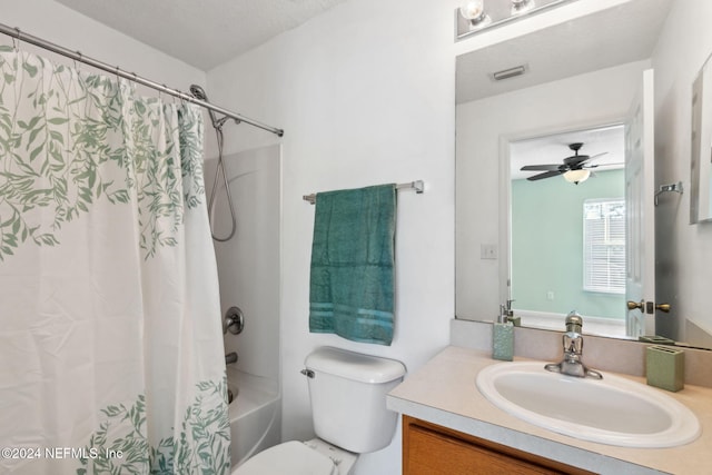 full bathroom with ceiling fan, a textured ceiling, toilet, shower / bath combo with shower curtain, and vanity