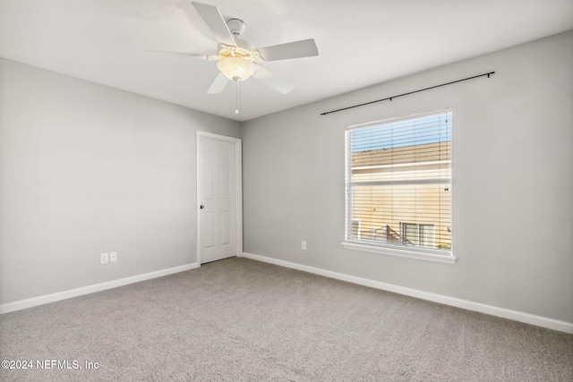 spare room featuring carpet and ceiling fan