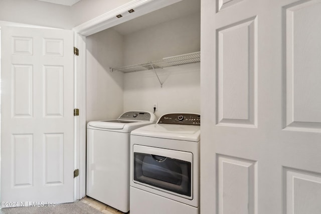 laundry room with washing machine and clothes dryer