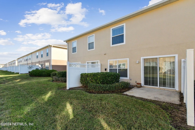 rear view of property with a yard