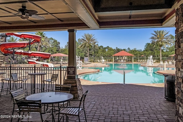 view of pool with a gazebo, a patio, ceiling fan, and a water slide