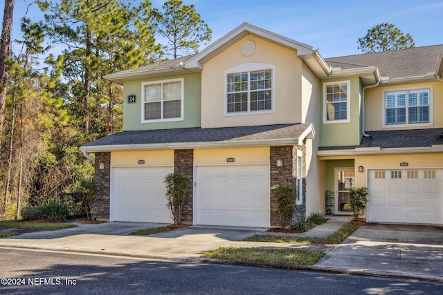 multi unit property featuring a garage