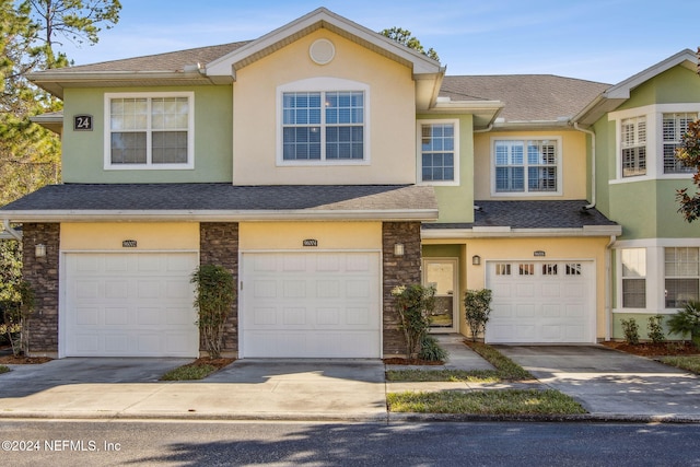 townhome / multi-family property featuring a garage