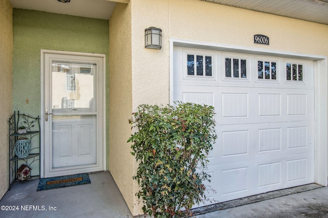 doorway to property featuring a garage