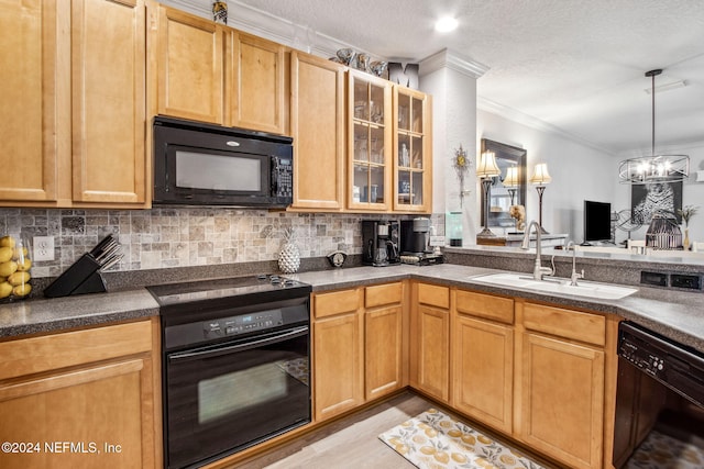 kitchen featuring black appliances, sink, light hardwood / wood-style flooring, ornamental molding, and a chandelier