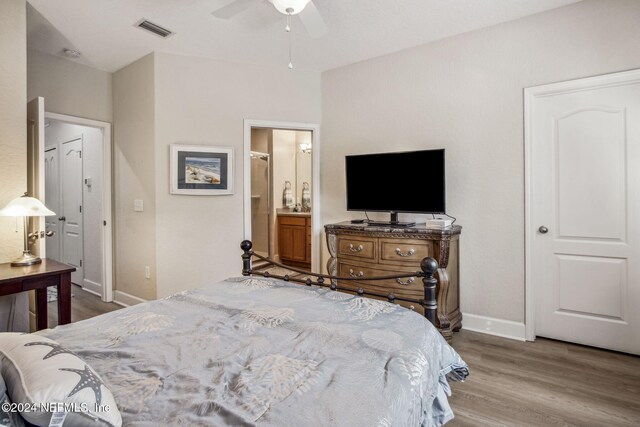 bedroom with ceiling fan, wood-type flooring, and ensuite bathroom