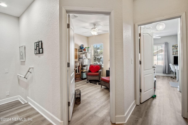 hall with light hardwood / wood-style floors