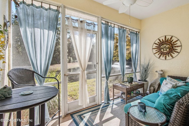 sunroom / solarium with plenty of natural light and ceiling fan