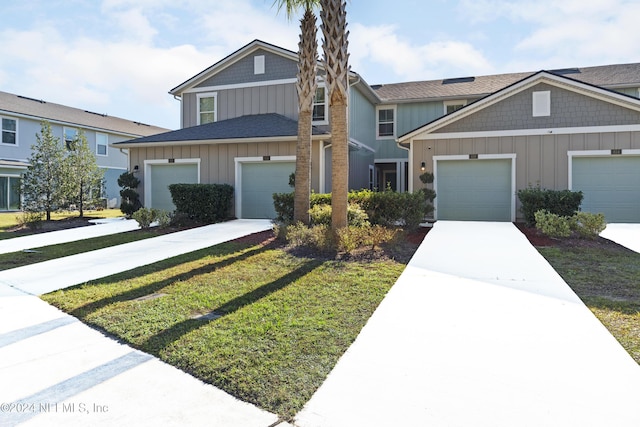 view of front of property featuring a garage and a front lawn