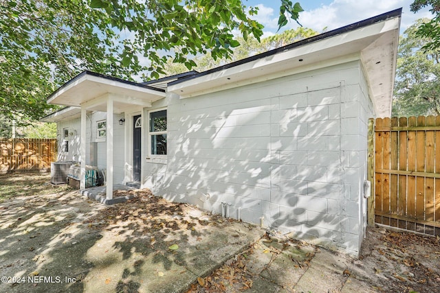 view of side of home featuring central AC