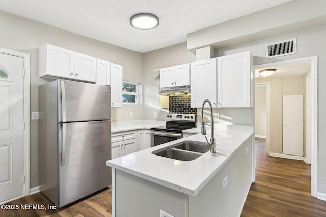 kitchen featuring light stone countertops, white cabinetry, stainless steel appliances, and dark wood-type flooring