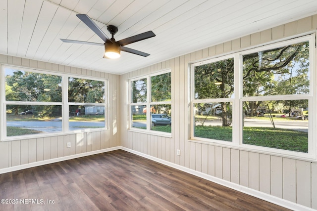 unfurnished sunroom featuring ceiling fan