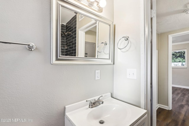 bathroom featuring vanity, a textured ceiling, and hardwood / wood-style flooring